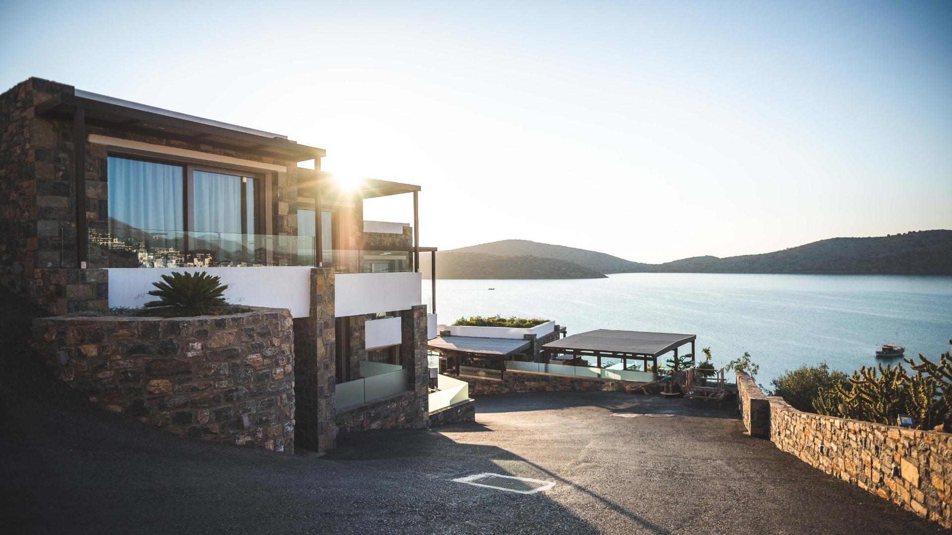 Coastal home terrace overlooking the water at sunset
