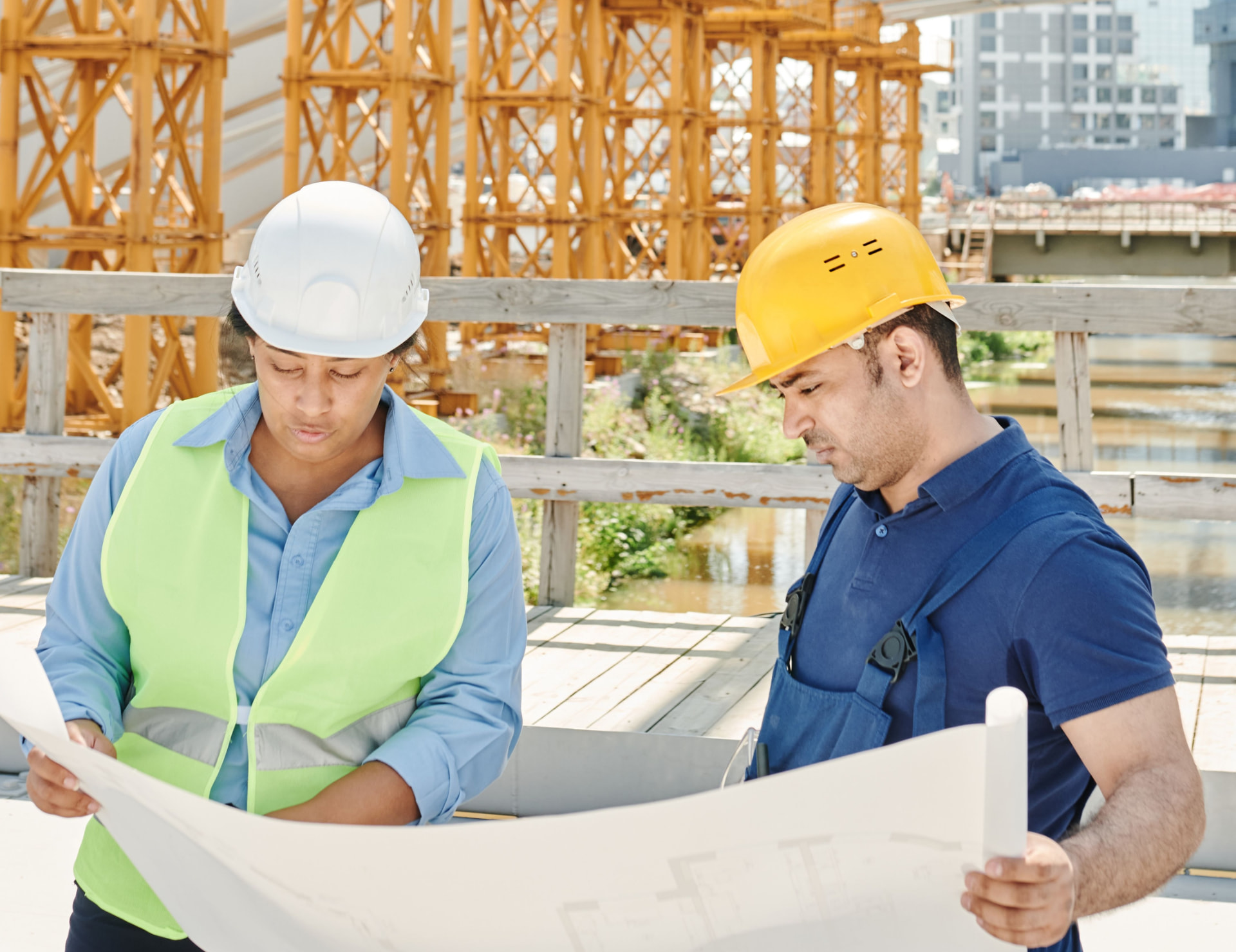 Construction professionals reviewing blueprints together on site